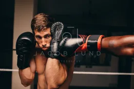 Boxing athlete blocking a punch to his jaw